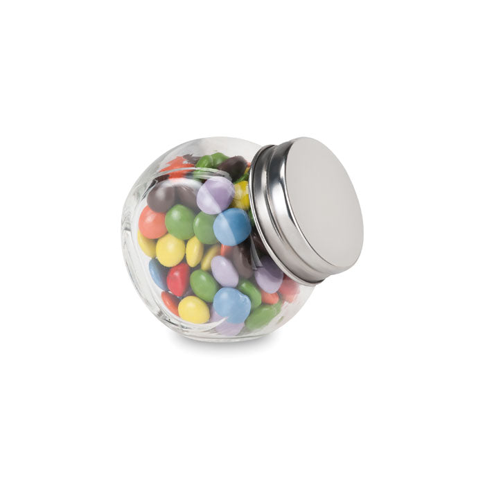 Chocolate lentils in a glass dispenser